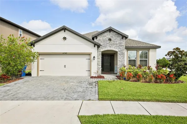 a view of a house with a yard and garage