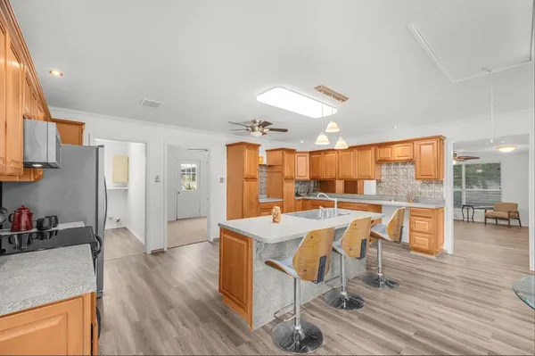 a very nice looking dining room with a large window and stainless steel appliances