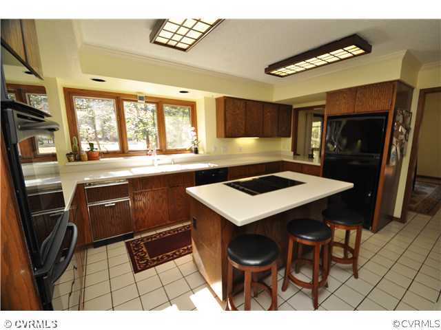 3904 Timber Ridge Road Midlothian, VA 23112 - Photo 2 of 12 a kitchen with a sink a stove a microwave a counter top space and cabinets