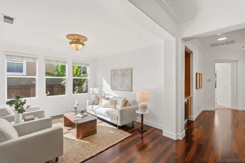 a living room with furniture and a wooden floor
