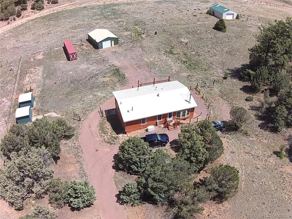 an aerial view of a house with a yard