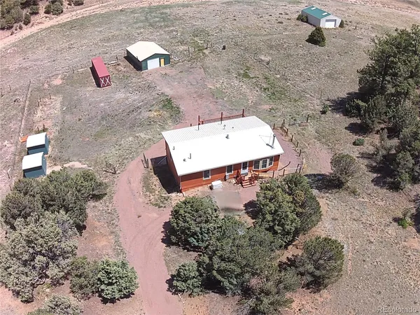 an aerial view of a house with a yard