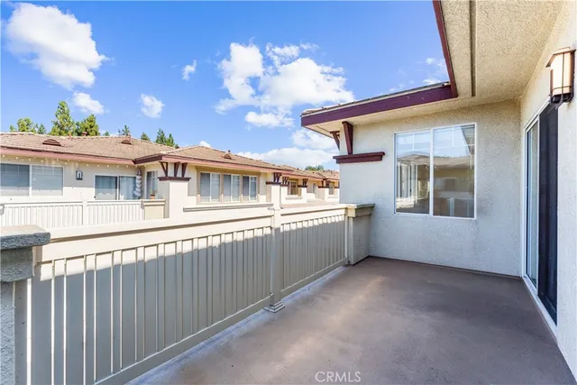 a view of wooden floor a fire place and a window in a room
