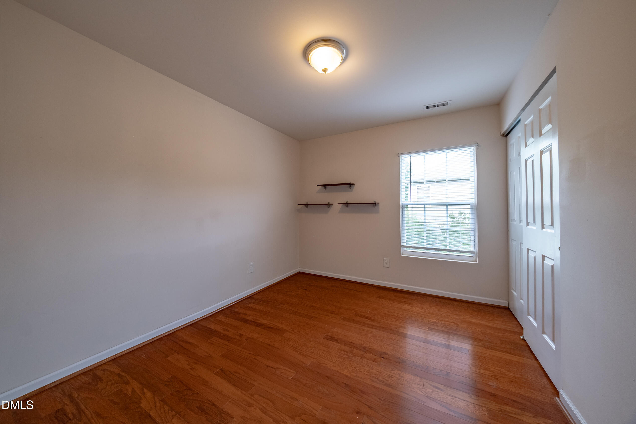 719 Obsidian Way Durham, NC 27703 - Photo 26 of 41 an empty room with wooden floor and windows