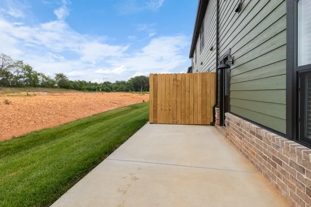 an empty room with a window and a ceiling fan