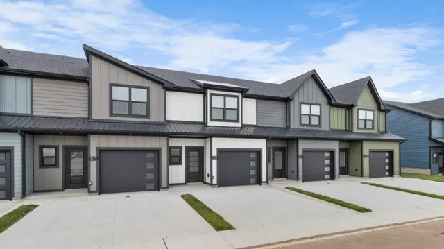 a front view of a house with yard and garage