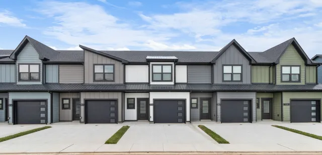 a view of a white house with large windows