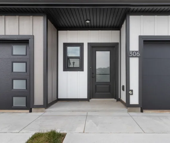 a view of a hallway with wooden floor and stairs