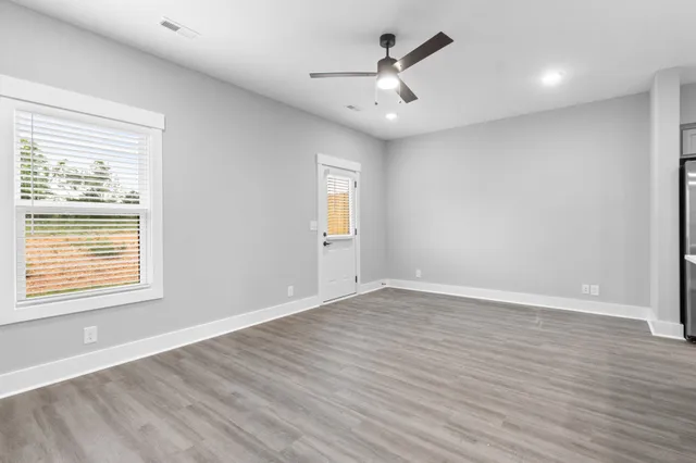 a kitchen with stainless steel appliances kitchen island a refrigerator sink and cabinets