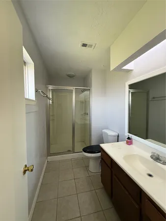 a bathroom with a double vanity sink a mirror and a bathtub