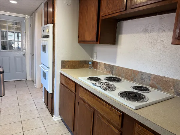 a kitchen with a stove and a refrigerator