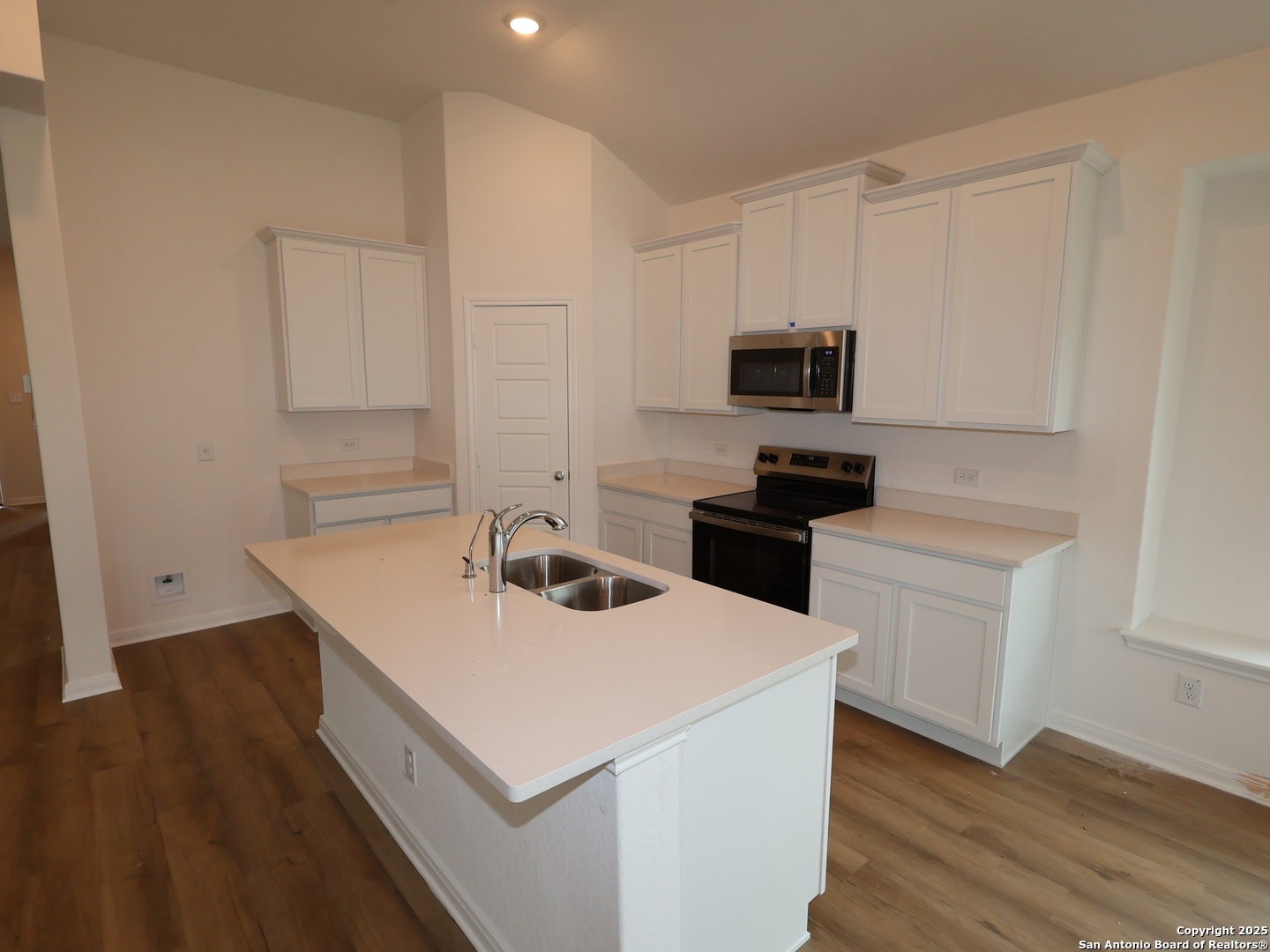 1164 Limestone Ridge Seguin, TX 78155 - Photo 2 of 45 a kitchen with sink cabinets and wooden floor