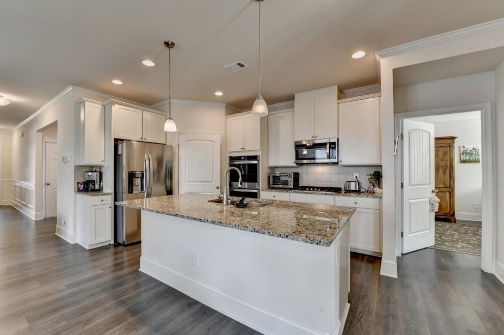 7535 Rambling Vale Dawsonville, GA 30534 - Photo 15 of 69 a large kitchen with stainless steel appliances kitchen island a large counter top and wooden floors