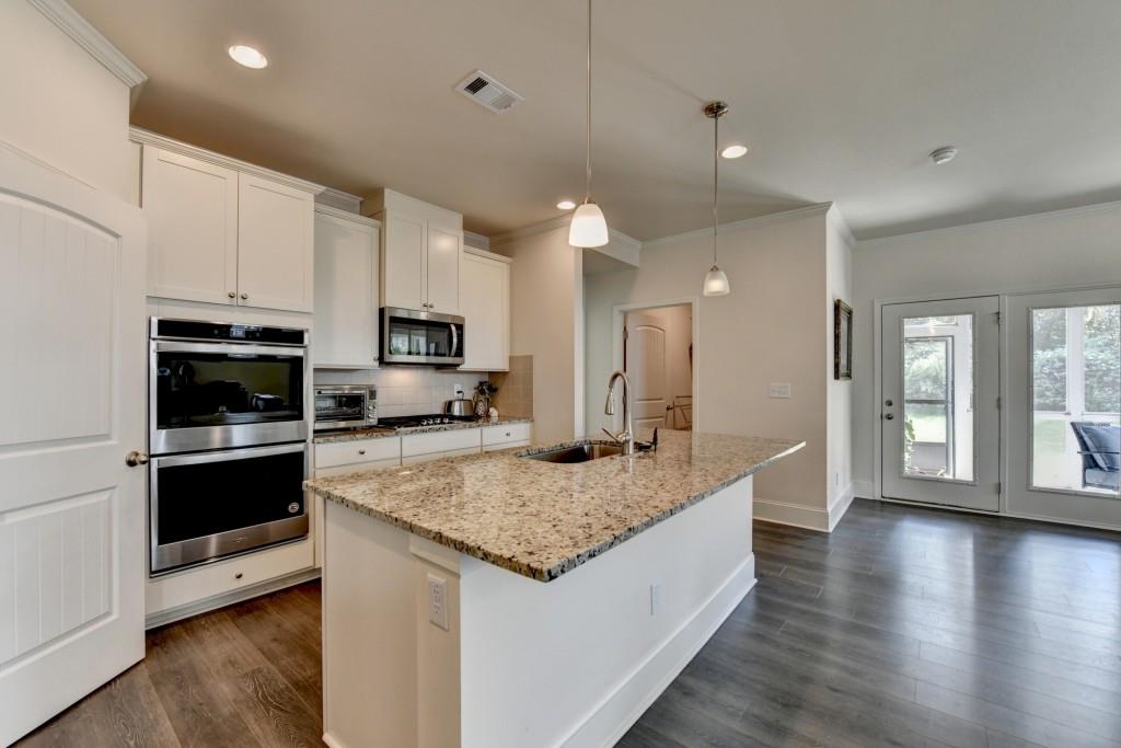 7535 Rambling Vale Dawsonville, GA 30534 - Photo 17 of 69 a kitchen with stainless steel appliances granite countertop a sink a stove and a wooden floors