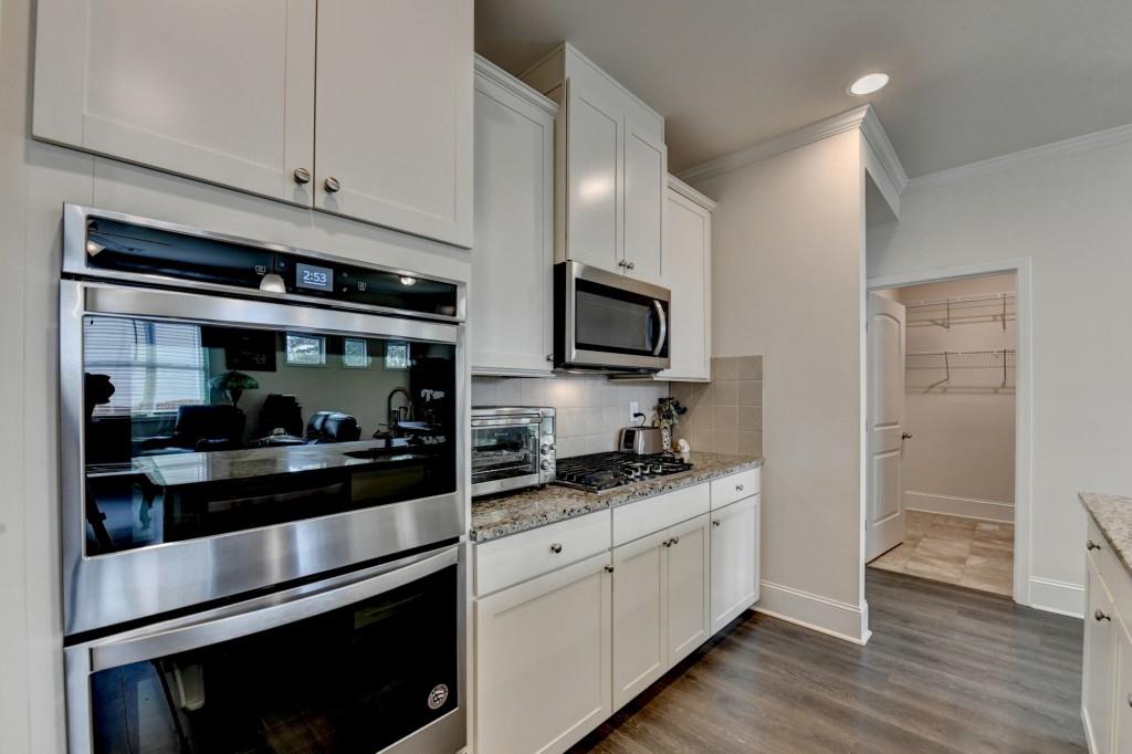 7535 Rambling Vale Dawsonville, GA 30534 - Photo 20 of 69 a kitchen with stainless steel appliances white cabinets and a sink
