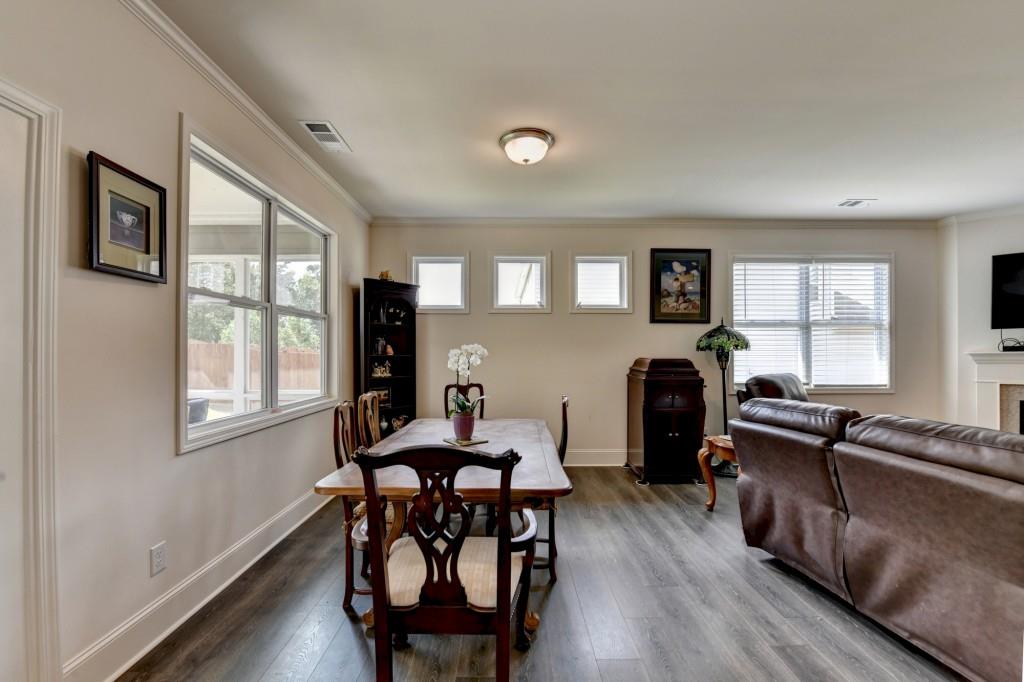 7535 Rambling Vale Dawsonville, GA 30534 - Photo 24 of 69 a view of a dining room with furniture window and wooden floor