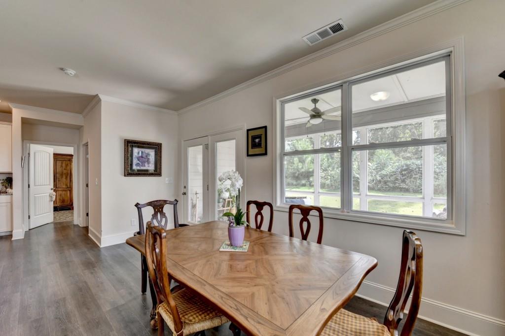 7535 Rambling Vale Dawsonville, GA 30534 - Photo 25 of 69 a dining room with furniture and wooden floor