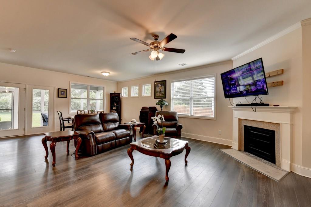 7535 Rambling Vale Dawsonville, GA 30534 - Photo 29 of 69 a living room with furniture a fireplace and wooden floor