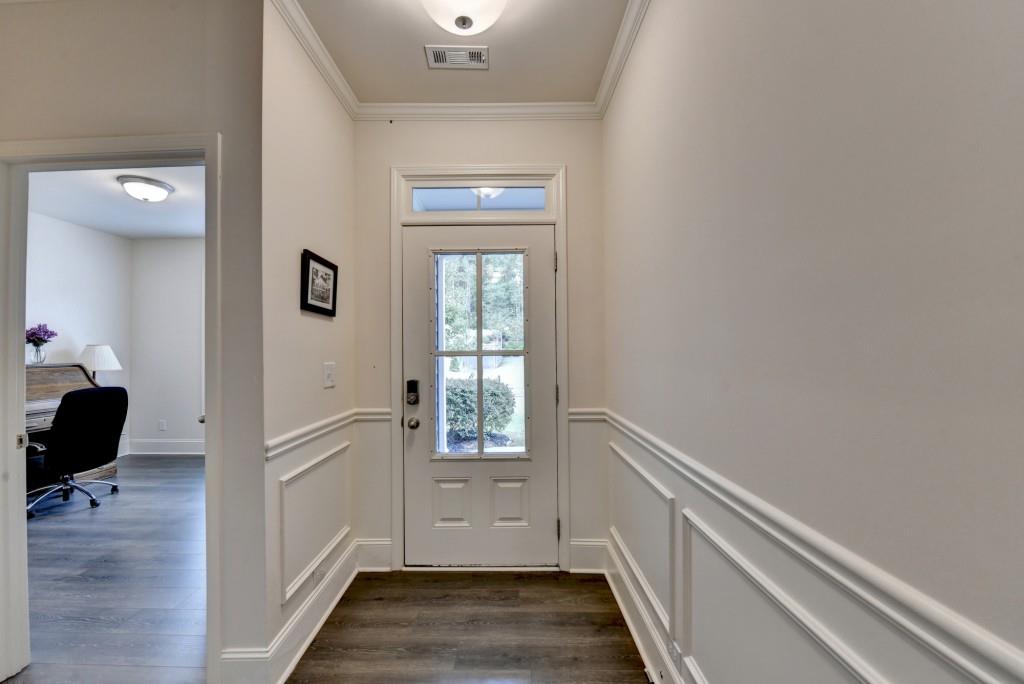 7535 Rambling Vale Dawsonville, GA 30534 - Photo 4 of 69 a view of a hallway with wooden floor and a living room