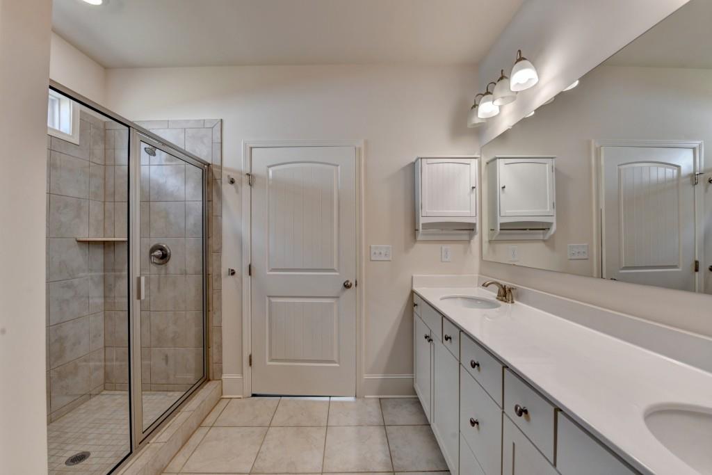 7535 Rambling Vale Dawsonville, GA 30534 - Photo 43 of 69 a spacious bathroom with a shower sink and mirror