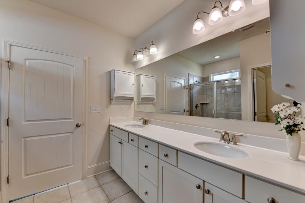 7535 Rambling Vale Dawsonville, GA 30534 - Photo 44 of 69 a bathroom with a double vanity sink a mirror and a shower