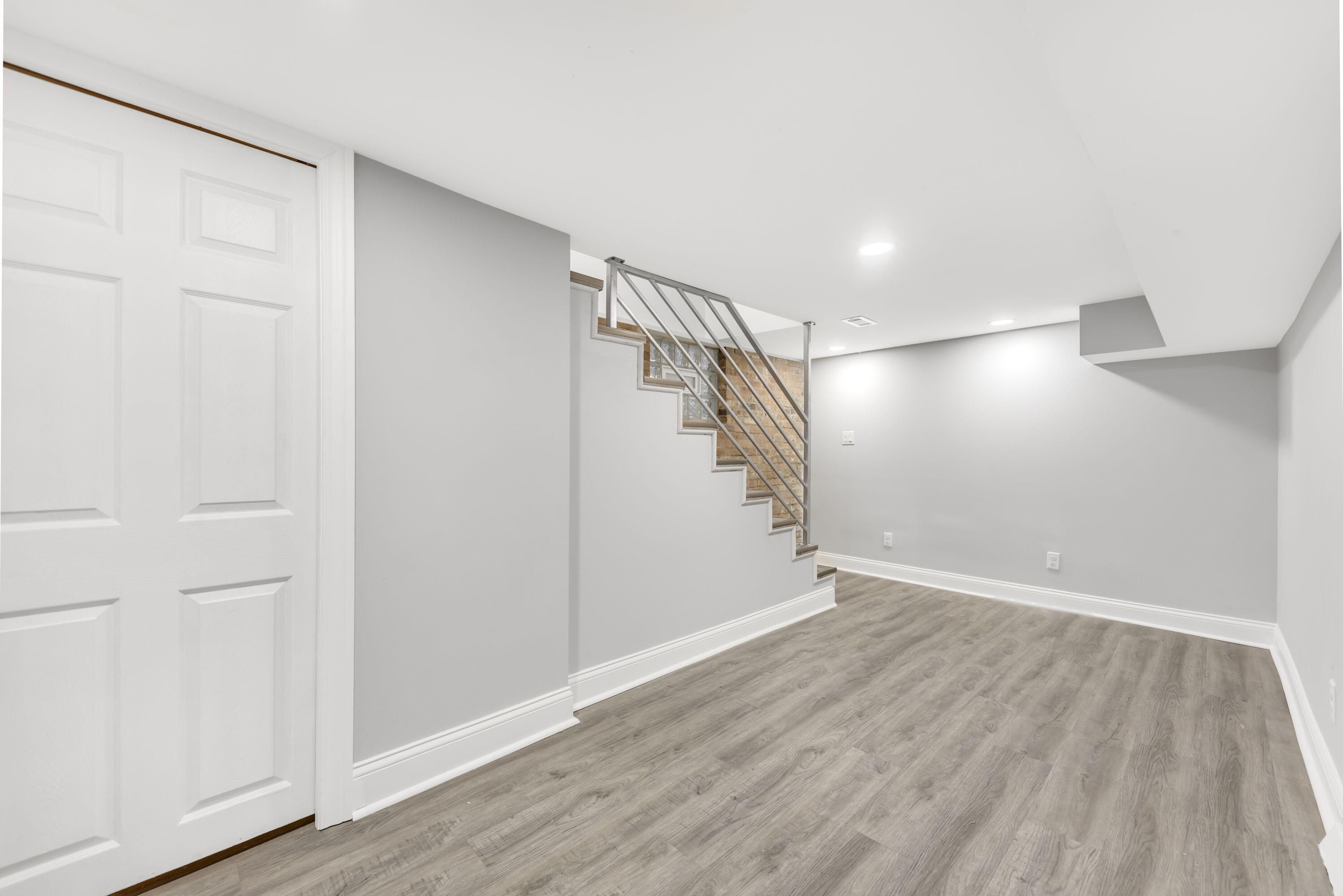 552 Harrison Street Gary, IN 46402 - Photo 11 of 14 a view of an empty room with wooden floor and stairs