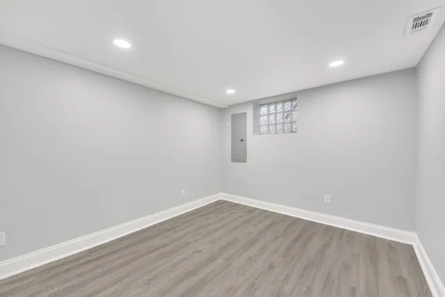 a view of an empty room with wooden floor