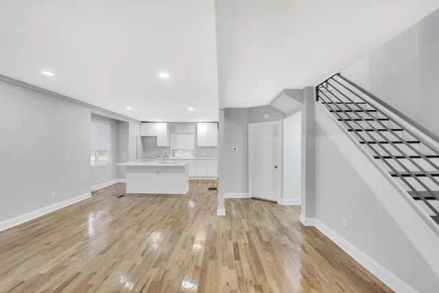 a view of a kitchen with wooden floor and electronic appliances