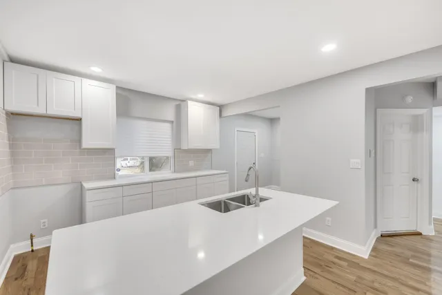 a kitchen with a sink and a refrigerator