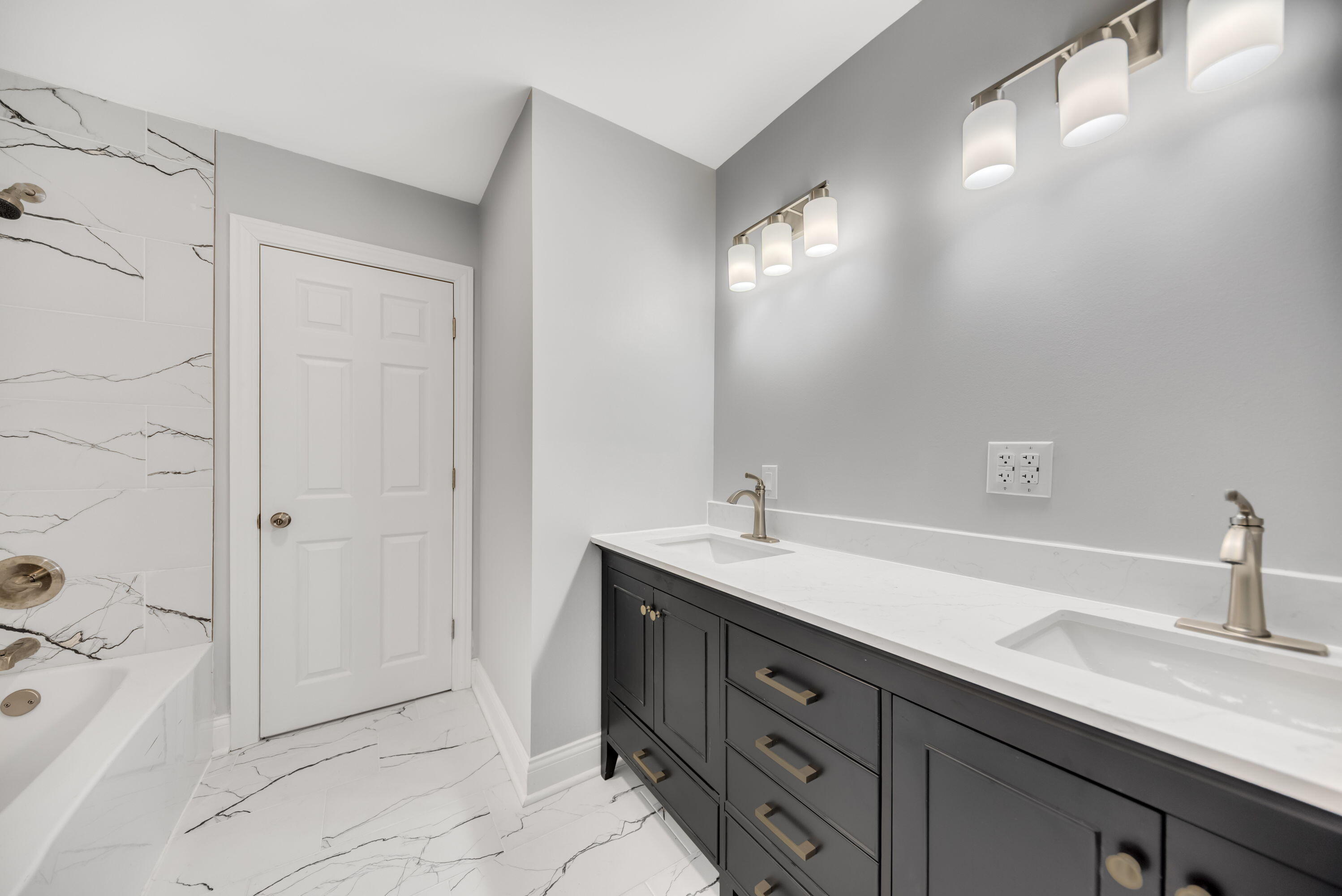 552 Harrison Street Gary, IN 46402 - Photo 7 of 14 a spacious bathroom with a double vanity sink a mirror and a bathtub