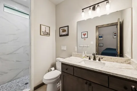 a bedroom with a bed and a chandelier