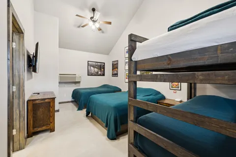 a bed sitting in a bedroom and painting on the wall