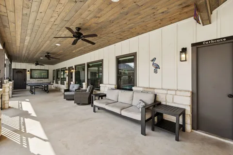 a lobby with furniture and a ceiling fan