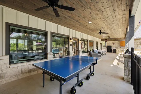 a swimming pool with outdoor seating and plants