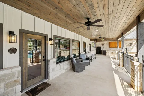 a view of a swimming pool with a patio and a yard