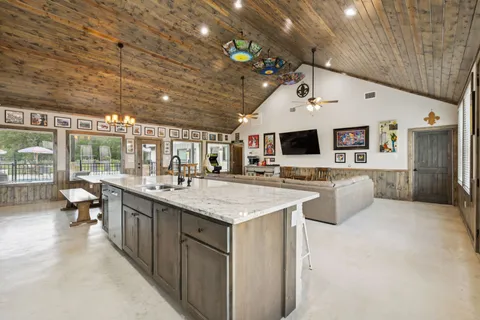 a large white kitchen with a large window