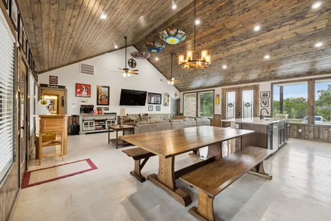 a large room with table tennis table and windows