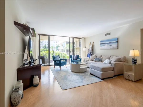 a living room with a table and a potted plant