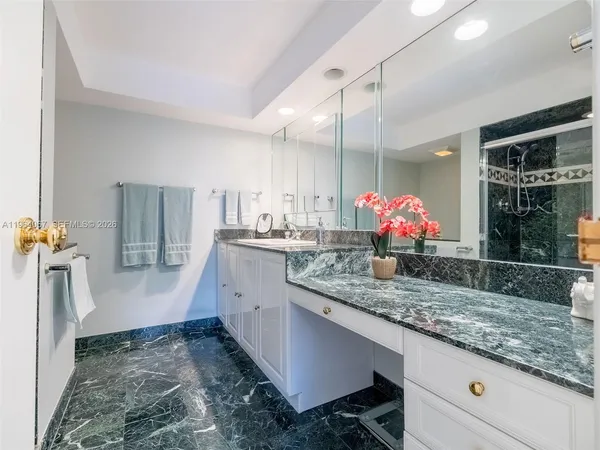 a bathroom with shower sink and mirror