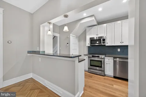 a bathroom with a granite countertop sink a mirror and vanity