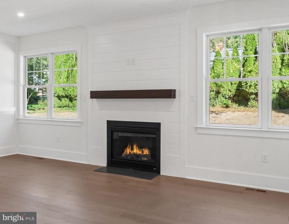 567 Southwood Road Hockessin, DE 19707 - Photo 11 of 54 a living room with a fireplace and a window