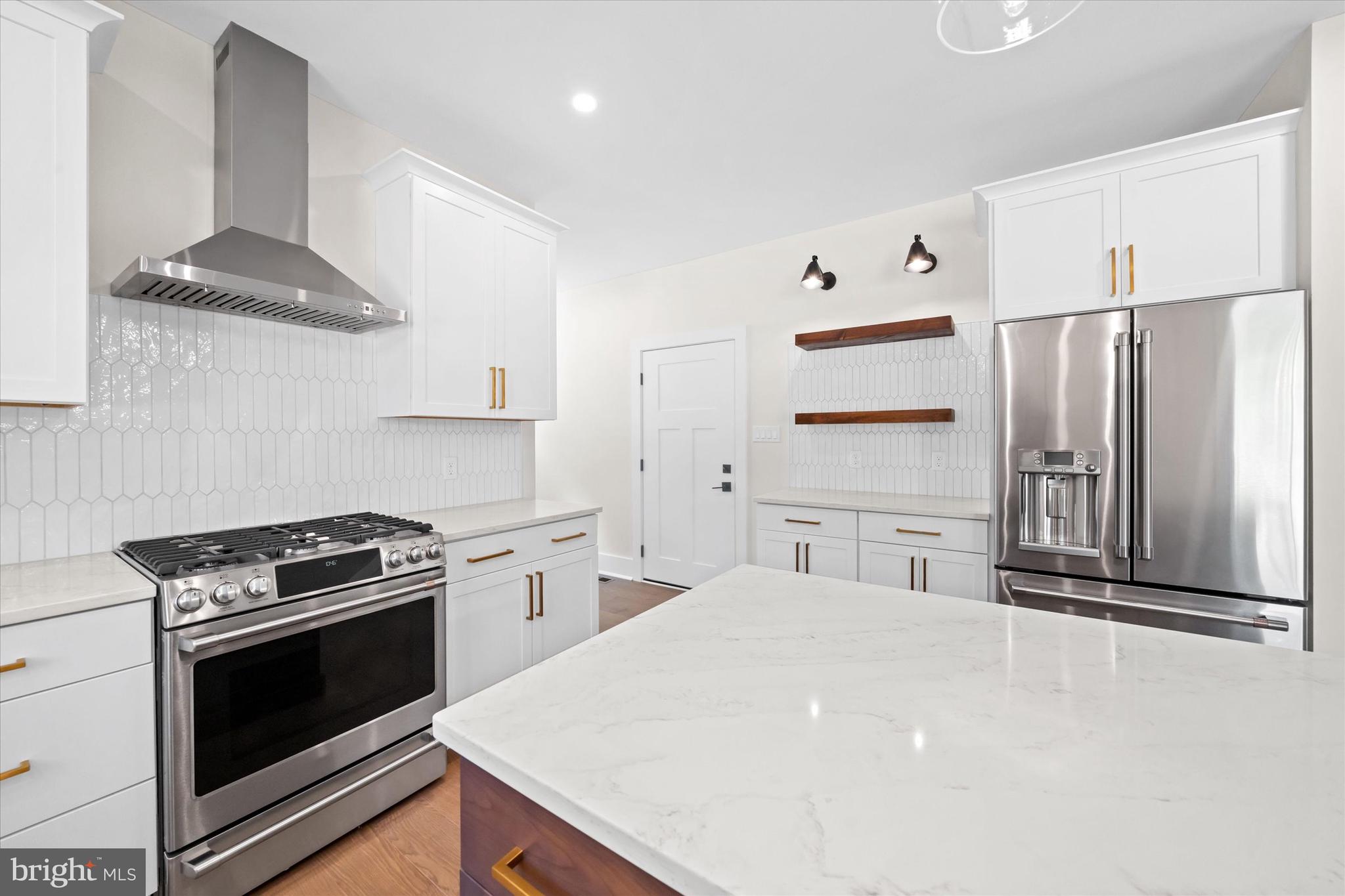 567 Southwood Road Hockessin, DE 19707 - Photo 15 of 54 a kitchen with stainless steel appliances a stove a sink and a refrigerator