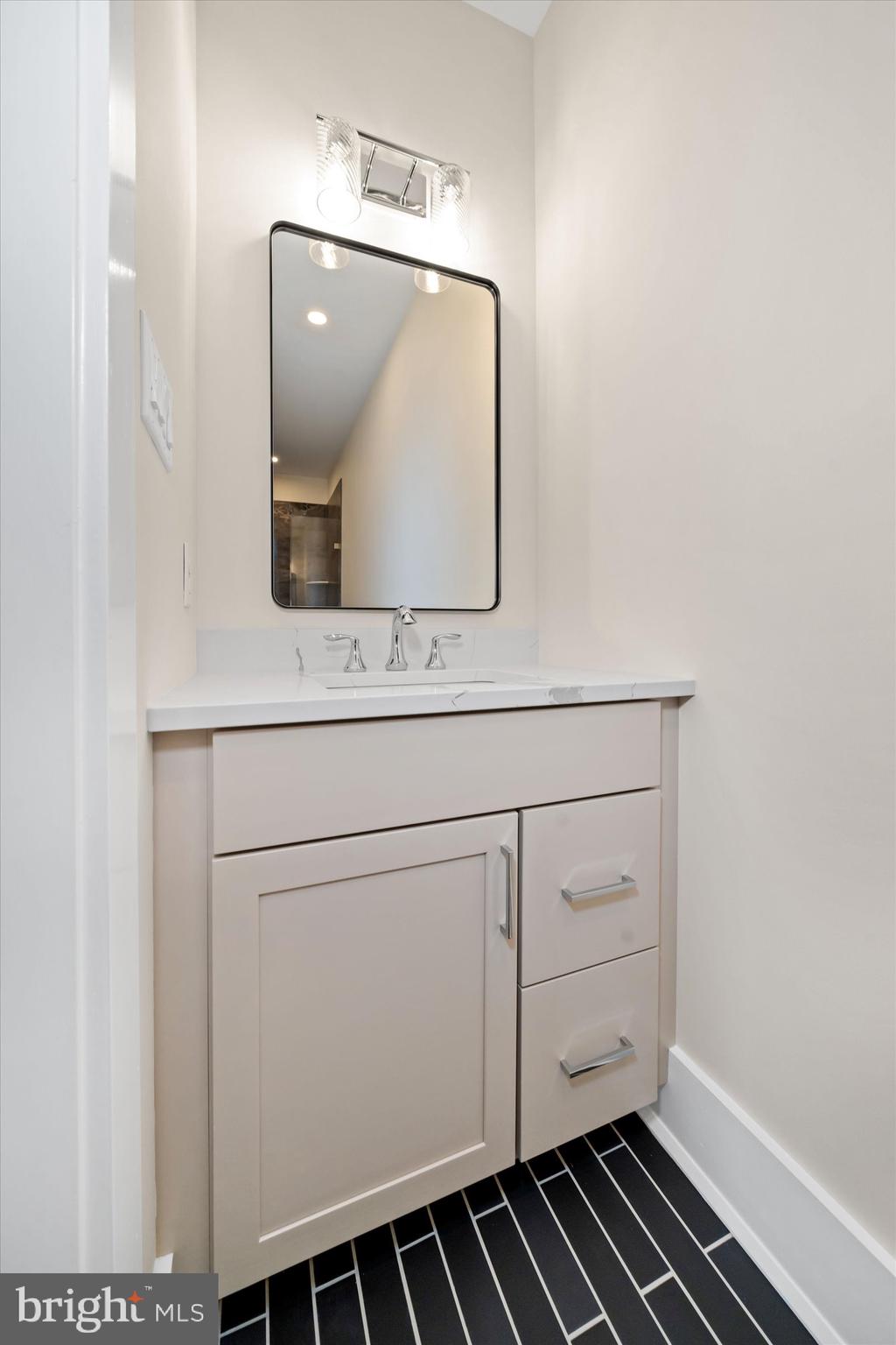 567 Southwood Road Hockessin, DE 19707 - Photo 26 of 54 a bathroom with a sink and a mirror
