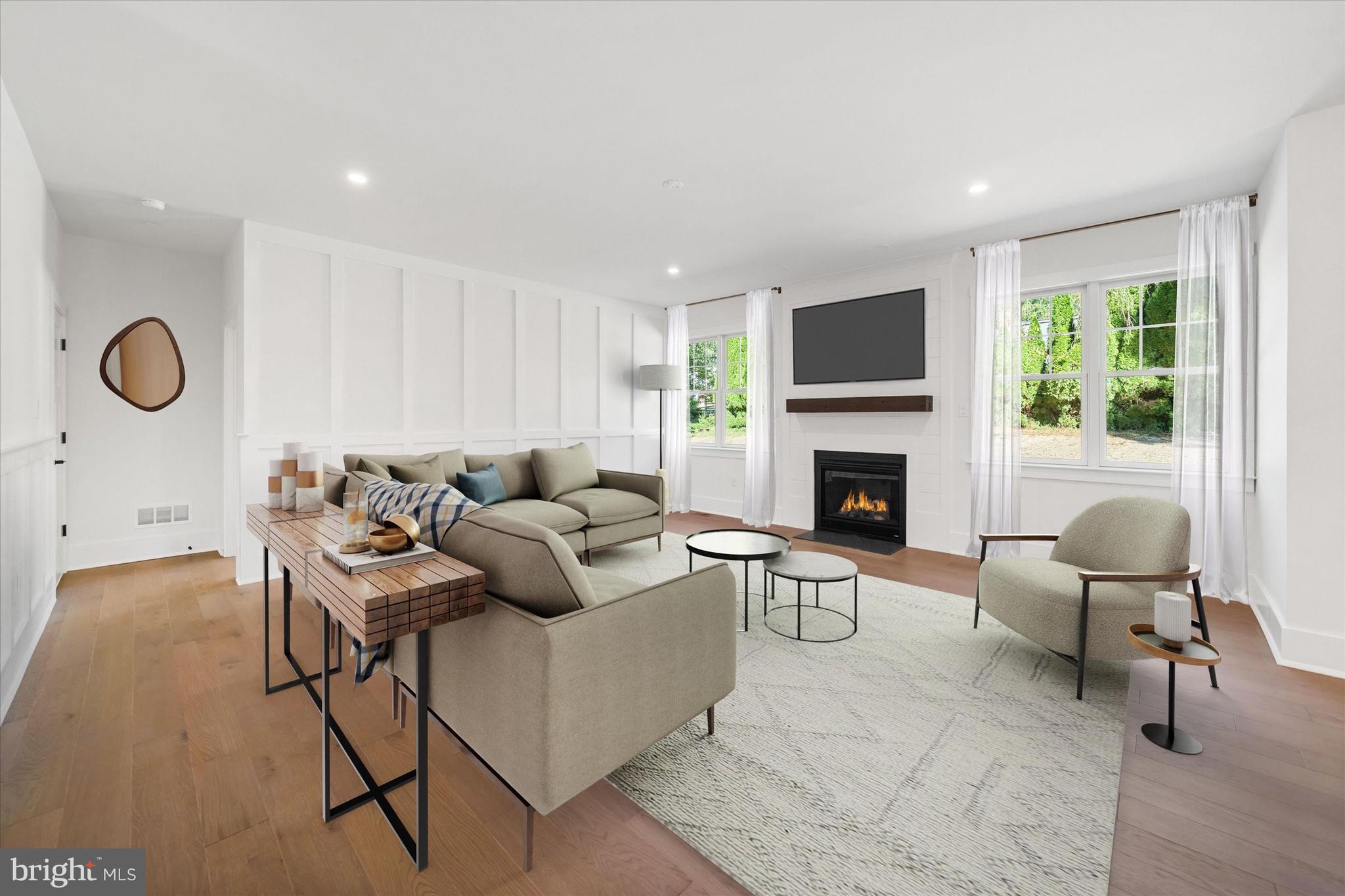 567 Southwood Road Hockessin, DE 19707 - Photo 9 of 54 a living room with furniture a fireplace and a flat screen tv