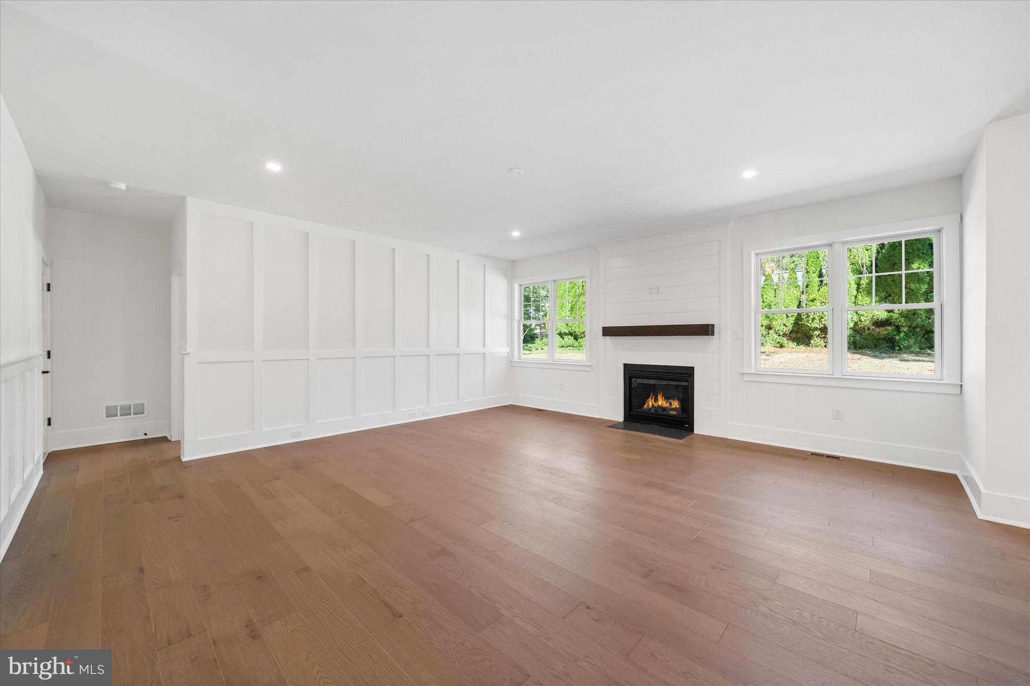 567 Southwood Road Hockessin, DE 19707 - Photo 10 of 54 an empty room with windows and fireplace