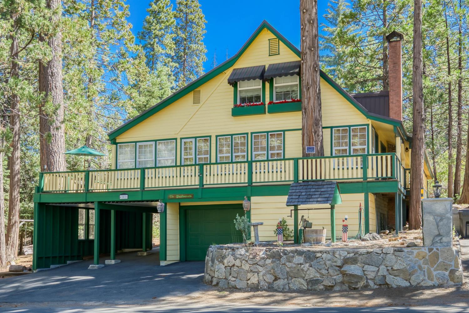 42025 Tollhouse Road Shaver Lake, CA 93664 - Photo 1 of 64 a front view of a house with a garden