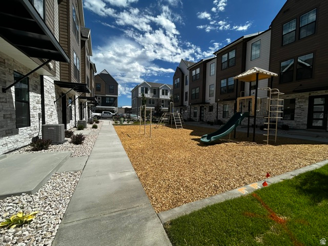 7331 South Sideline Lane, Unit 58 Midvale, UT 84047 - Photo 26 of 29 Community playground featuring a slide, climbing structure, and wood chip surfacing