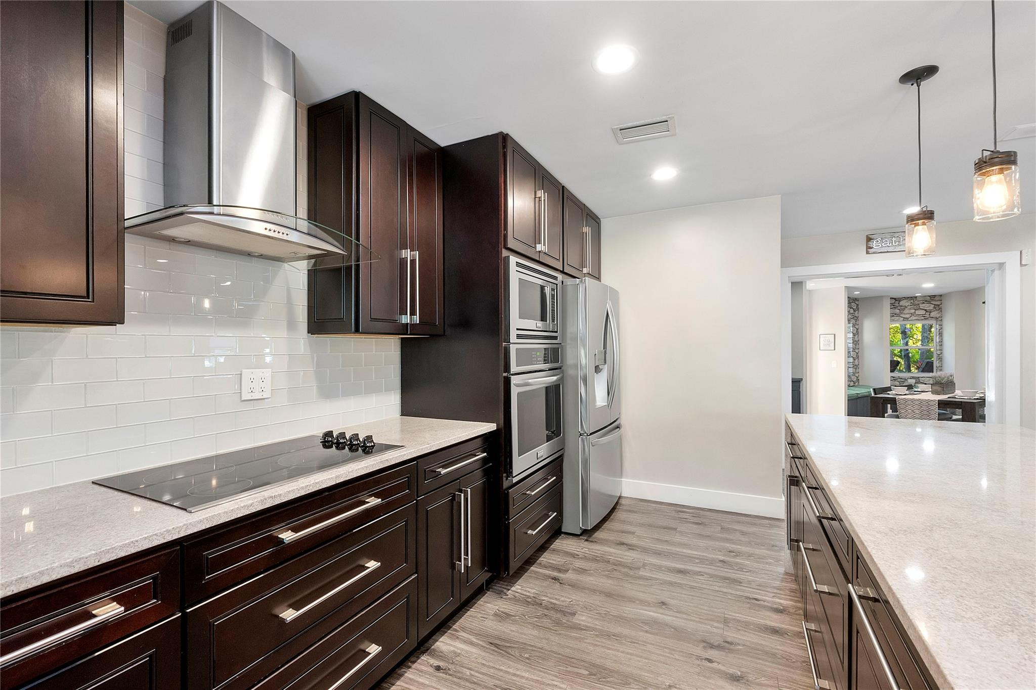 5351 Godfrey Road Parkland, FL 33067 - Photo 19 of 95 a kitchen with stainless steel appliances sink stove refrigerator and cabinets