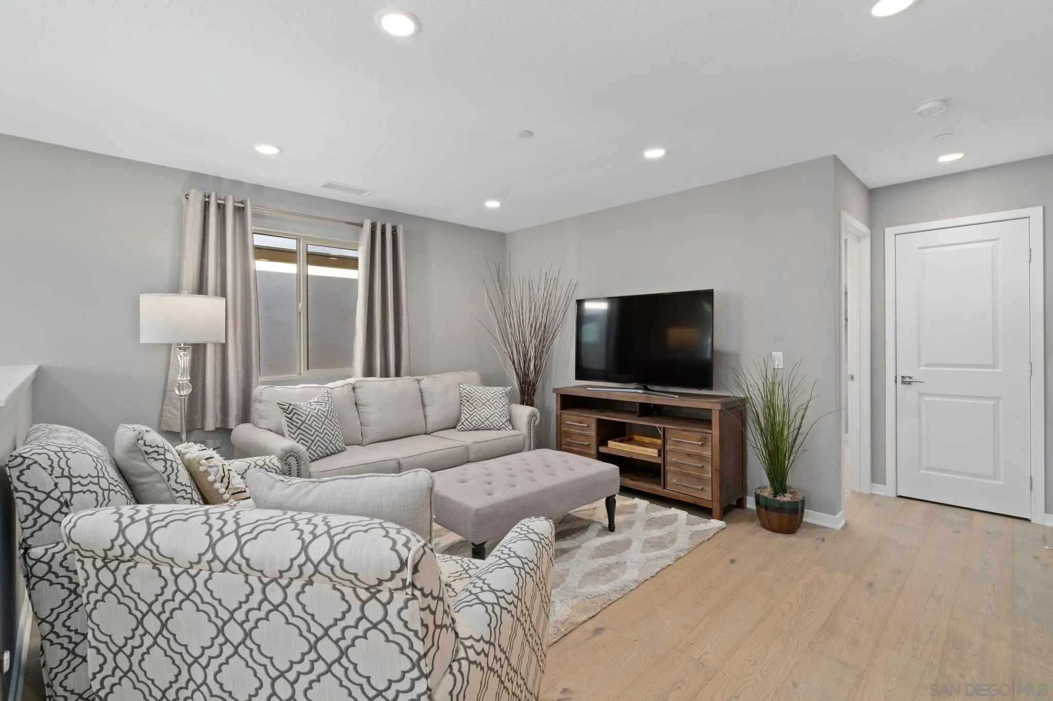 8347 Ridge Court San Diego, CA 92108 - Photo 16 of 63 a living room with a couch and a flat screen tv
