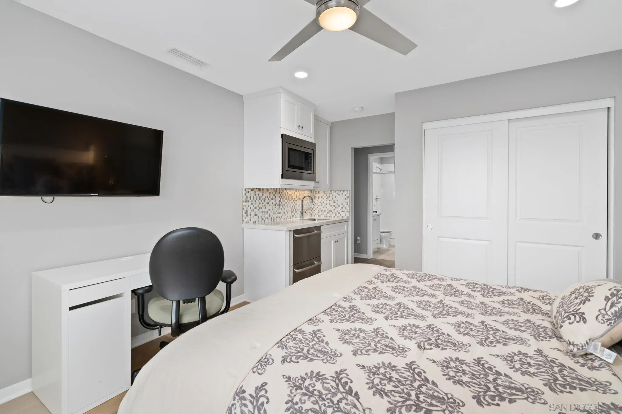 8347 Ridge Court San Diego, CA 92108 - Photo 28 of 63 a bedroom with a bed a flat screen tv and a chair